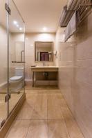 a bathroom with a sink and a toilet and a mirror at Renion Park Hotel in Almaty
