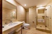 a bathroom with a toilet and a sink and a shower at Renion Park Hotel in Almaty