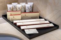 a pile of boxes of soap and candles on a counter at Renion Park Hotel in Almaty