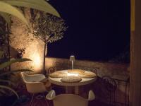 a table and chairs on a patio at night at Residence Les Sources in Brando