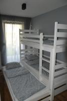 Postel nebo postele na pokoji v ubytování Apartament Rodzinny Jantar Park