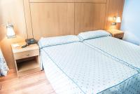 A bed or beds in a room at Reino de Granada