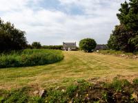 an empty field with a house in the background at Holiday Home Ker Kébec by Interhome in Crozon