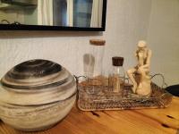 a table with two wooden figurines and a jar on it at STUDIO avec PARKING TOUT A PIED et CALME in Bandol