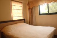 a bedroom with a white bed and a window at Emmanuel Farm House in Ren&#39;ai