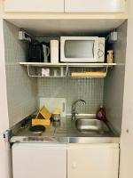 a small kitchen with a sink and a microwave at Studio des Carmes in Toulouse