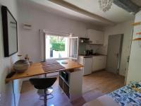 a kitchen with a desk and a window in a room at STUDIO avec PARKING TOUT A PIED et CALME in Bandol