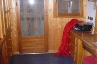 a small kitchen with a wooden door and a counter at Le chalet de Julbert in Combloux