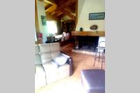 a living room with a couch and a fireplace at Le chalet de Julbert in Combloux