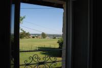 an open window with a view of a field at Champ Fleuri in Angoulême