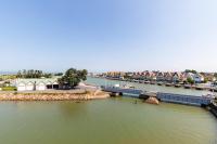 an aerial view of a river with houses and a dock at Gwenhen - Appartement vue mer in Courseulles-sur-Mer