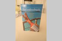 a book hanging on a wall with a picture of a person with a laptop at Evita Wörthersee in Krumpendorf am Wörthersee