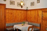 a dining room with wooden walls and a table and chairs at Hotel Tauernpasshöhe in Obertauern