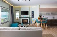 a living room with a couch and a table and a kitchen at Kyma Seafront Suite by Estia in Kokkini Khanion