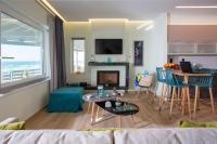 a living room with a couch and a table at Kyma Seafront Suite by Estia in Kokkini Khanion