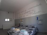 A bed or beds in a room at CASA ALEXSA Intero appartamento o CAMERA ALEXSA Camera matrimoniale con patio