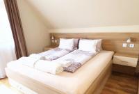 Łóżko lub łóżka w pokoju w obiekcie Apartman Siesta Bük - Bükfürdő