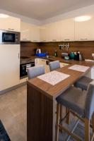 A kitchen or kitchenette at Zsuka apartman free parking