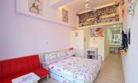 a bedroom with a red bed and a red couch at Wan-Yue B&amp;B in Hengshan