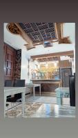 a dining room with a table and a bar at Sacristia de Santa Ana in Seville