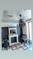 a dining room with a table and chairs and a chandelier at Sacristia de Santa Ana in Seville