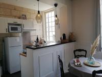 a kitchen with a counter and a table and a microwave at Vieux Tours, Charmant T2 40m2, 4 pers, lumineux in Tours