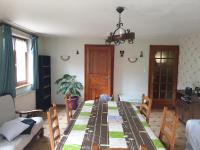 a living room with a long table with chairs at le gutty - maison de vacances in Natzwiller
