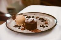 a plate with a piece of cake and ice cream at Le Taha'a by Pearl Resorts in Motu Tautau