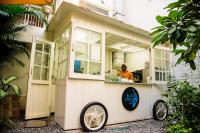 a man sitting at a counter in a tiny house at Stay Banaras - A Boutique Hotel in Varanasi