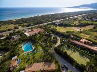 an aerial view of a resort with a pool and the ocean at Hotel Punta Sur in Tarifa