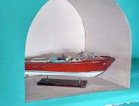 a small red and white boat on display in a room at Hôtel Restaurant Villa Riva in Veyrier-du-Lac