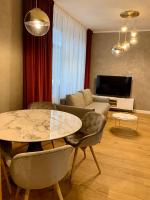 Televízia a/alebo spoločenská miestnosť v ubytovaní Rosso Aparthotel