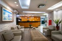 a large living room with couches and a kitchen at Hotel Santorini in Vila Velha