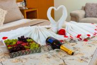 a table with a tray of fruit and a bottle of wine at Hotel Santorini in Vila Velha