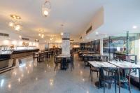 um restaurante com mesas, cadeiras e um bar em MinaMark Beach Resort for Families and Couples Only em Hurghada