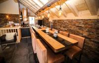a dining room with a long table and leather chairs at Odalys Chalet Les Lions Blancs in Valloire