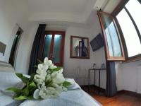A bed or beds in a room at EMI's Guest House