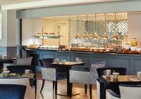 a restaurant with tables and chairs and a counter at Formby Hall Golf Resort & Spa in Southport