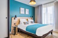 Un dormitorio con una cama grande y una pared azul. en Appart&#39;City Confort St Quentin en Yvelines - Bois D&#39;Arcy, en Bois-d&#39;Arcy