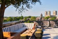 a patio with tables and chairs and a view of the city at Malmaison York in York