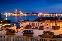 a balcony with a view of the water at night at Baglioni Hotel Luna - The Leading Hotels of the World in Venice