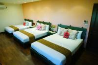 a hotel room with three beds with flowers on them at Sine Ya Hostel in Hengchun South Gate