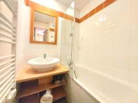a bathroom with a sink and a bath tub at Appartement La Plagne-Tarentaise, 1 pièce, 4 personnes - FR-1-351-146 in La Plagne Tarentaise