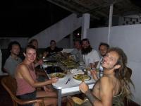 a group of men sitting around a table eating food at Jayanthi Surf Dreams in Midigama