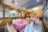 a banquet hall with pink tables and white chairs at Kenting Holiday Hotel in Hengchun South Gate