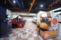 a room with arcade games and a checkered floor at Kenting Holiday Hotel in Hengchun South Gate