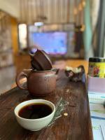 a cup of coffee and a tea pot on a table at 金門自由行民宿 Kinmentrip B&amp;B in Jincheng