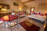 a room with two beds and a table and a kitchen at Gites Le Clos de Saires in Saires
