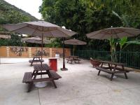 a group of picnic tables with umbrellas at Hotel Vila Suíça 1818 in Nova Friburgo