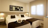 A bed or beds in a room at Aparthotel Solifemar